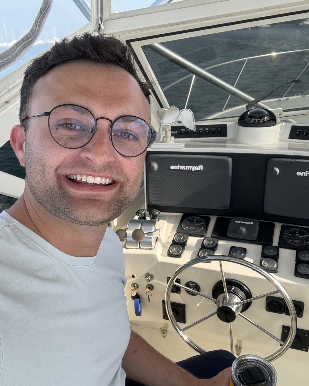 Jake, owner of Farholm, at the helm of a boat on the water